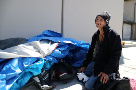 Carmen Ramirez, 78, puts away belongings in front of the tent in which she sleeps on the street in Los Angeles, California, U.S. March 29, 2018. REUTERS/Lucy Nicholson