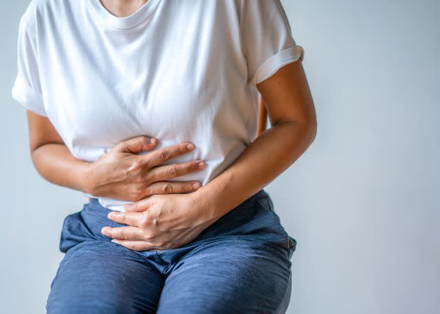 <p>Getty</p> Getty image of woman with stomach ache.