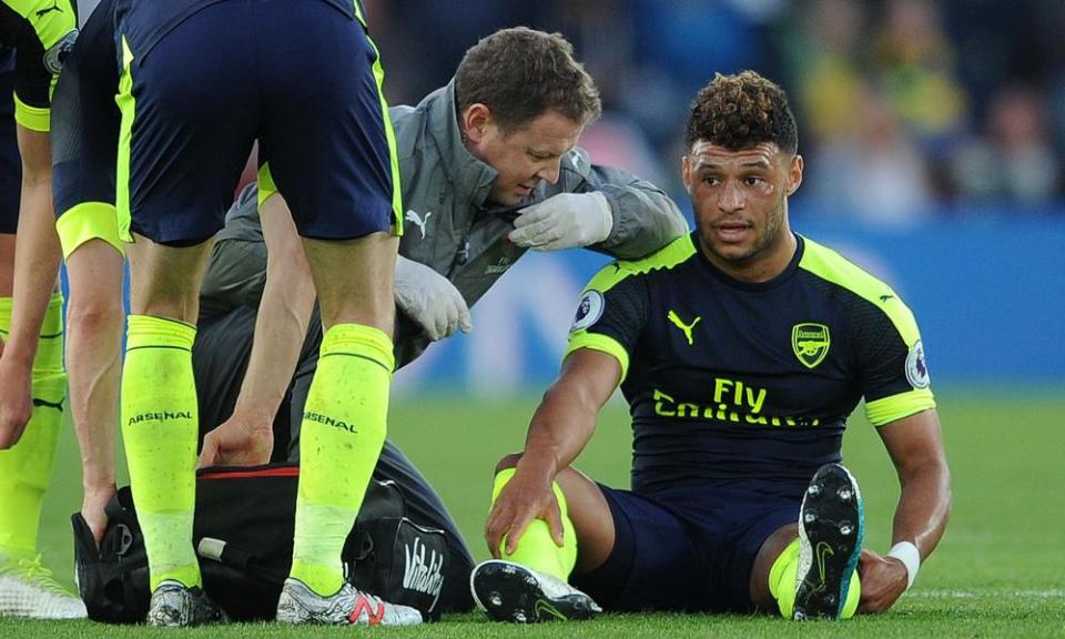 Alex Oxlade-Chamberlain is treated for a hamstring problem before being taken off in Arsenal’s 2-0 win over Southampton in May