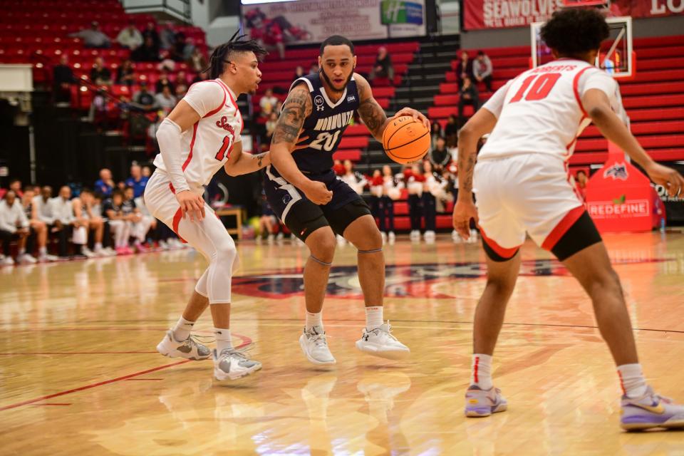 Monmouth's Tahron Allen works against a Stony Brook defender on Feb. 8, 2023, in Stony Brook, New York.