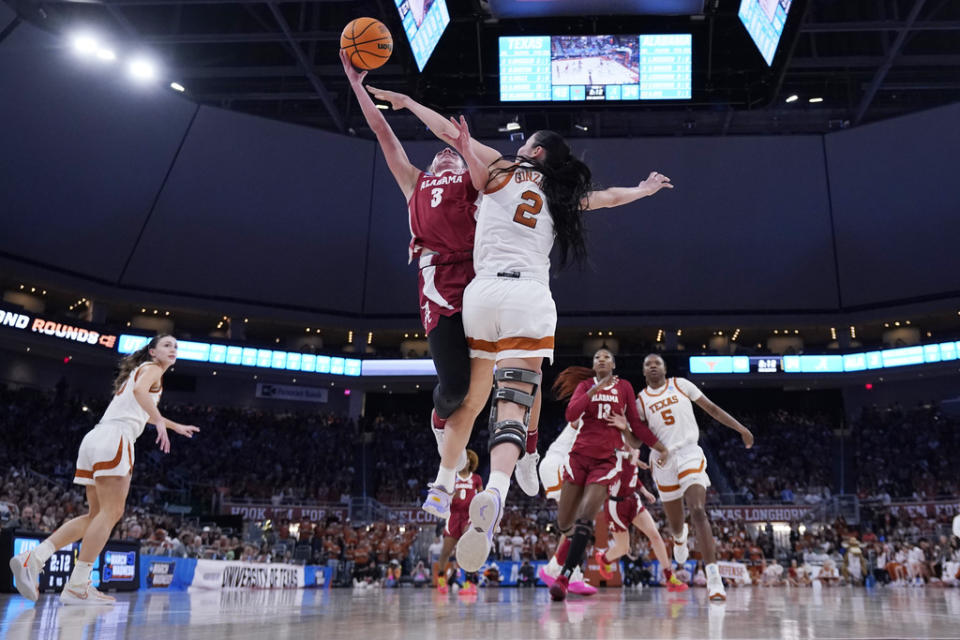Alabama guard Sarah Ashlee Barker (3) is blocked by Texas guard Shaylee Gonzales (2) as she drives to the basket during the second half of a second-round college basketball game in the women’s NCAA Tournament in Austin, Texas, Sunday, March 24, 2024. (AP Photo/Eric Gay)