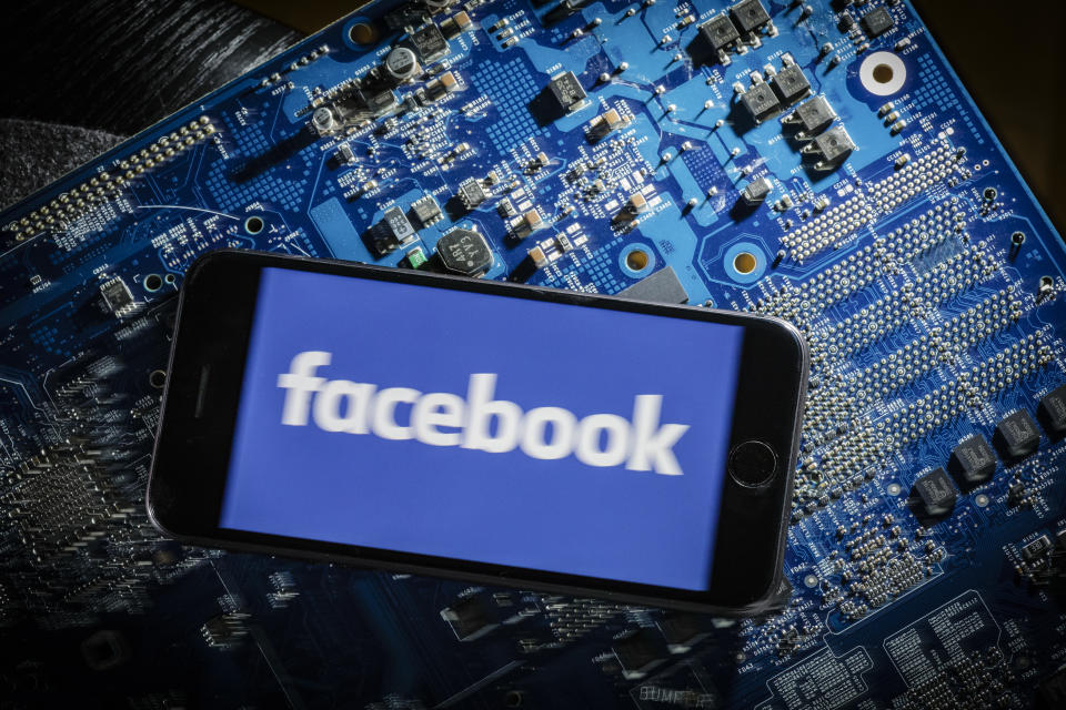 Berlin, Germany - March 20: In this photo illustration the logo of Facebook is displayed on a smartphone which is lying on a circuit board on March 20, 2018 in Berlin, Germany. (Photo by Thomas Trutschel/Photothek via Getty Images)