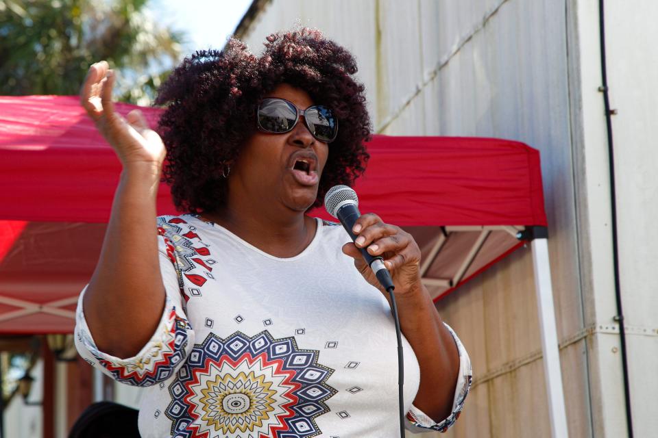 Service is held under a large tent near Lilly Bass Church of God in Unity in Immokalee, Fla., on Sunday, Oct. 16, 2022. The congregation of Lilly Bass, anywhere from 25-50 people, now worships near the ashes of what once held their pentecostal church that burned down on Sept. 16, 2022. 