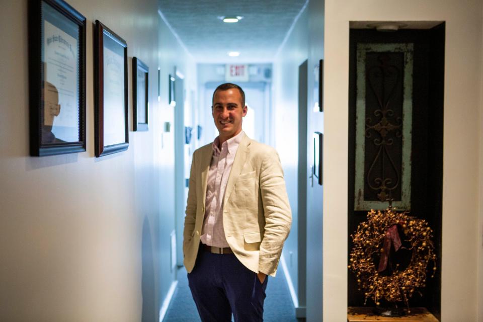 Justin Bruce, real estate agent and oner of Bruce Chiropractic, stands in the hallway at Bruce Chiropractic in Lancaster, Ohio on April 6, 2022.