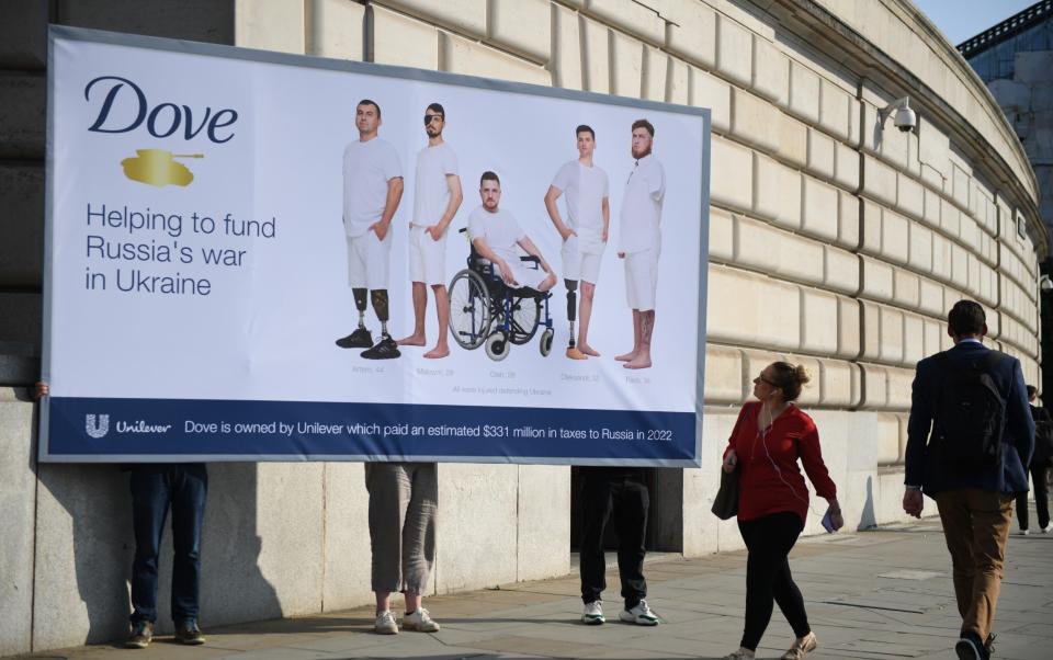 A billboard erected by activists in July 2023 outside Unilever's London headquarters showing wounded Ukrainian soldiers posing in the style of the company's Dove adverts