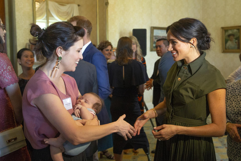 <p>Wearing the $2,500 frock, Meghan mingled with guests at Admiralty House. She is pictured here with Aussie singer Missy Higgins. Source: Getty </p>