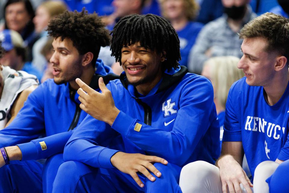 Kentucky guard Shaedon Sharpe, center, smiles from the bench during a game at Rupp Arena on Jan. 15.