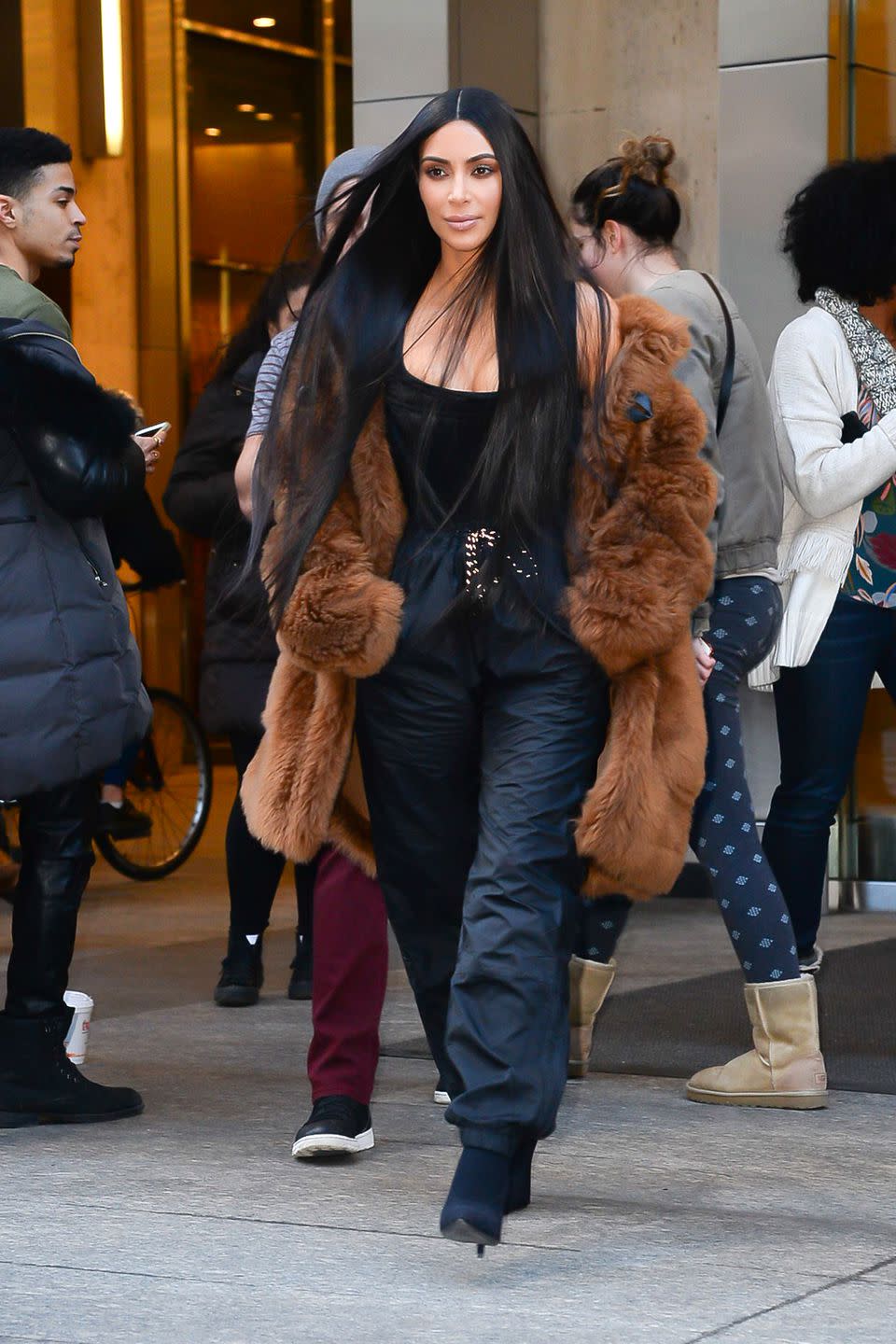 <p>In a brown fur coat, black tank top, drawstring sweat pants, and black ankle boots while out in New York.</p>