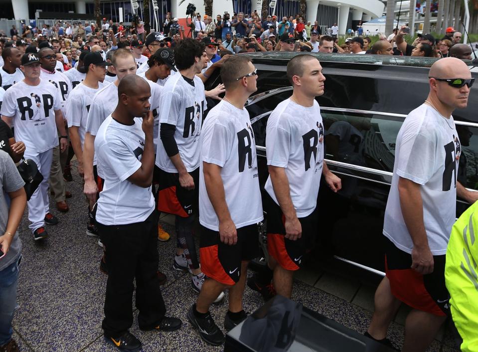 <p>Miami Marlins players and members of the Marlins organization and their fans walk next to the hearse carrying Miami Marlins pitcher Jose Fernandez to pay their respects as they pass in front of the Marlins baseball stadium on September 28, 2016 in Miami, Florida. Mr. Fernandez was killed in a weekend boat crash in Miami Beach along with two friends. (Photo by Joe Raedle/Getty Images) </p>