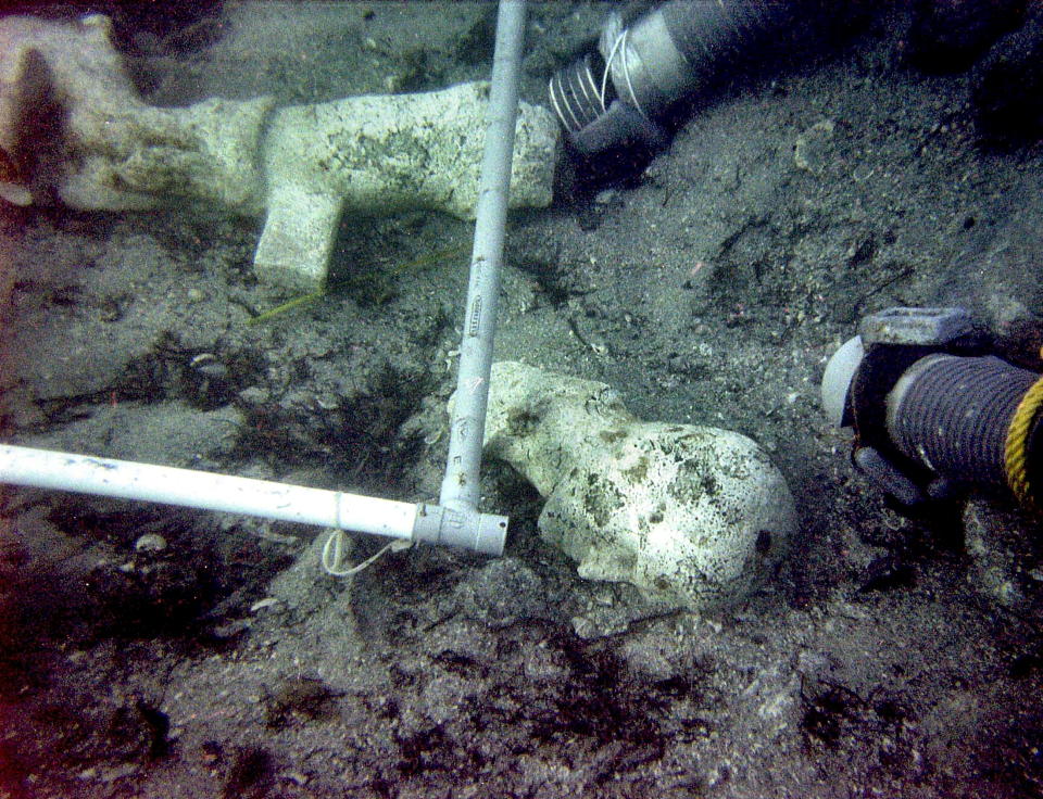 The bust of a statue (C) acheologists identify as Roman Emperor Philip the Arab, who ruled from 224 to 249 AD, is seen on underwater off the Mediterranean island of Corsica in this recent undated photo. Archeologists announced November 19, 2004 that a 2-metre statue of a feminine silhouette and statue fragments of the roman emperor were discovered October 23, 2004 in in shipwreck dating from the third century off Porticcio in southern Corsica. HO/Stringer/Reuters