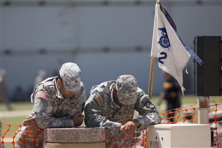 Two soldiers are pictured at a memorial service in Fort Hood in Killeen, Texas April 9, 2014. REUTERS/Julia Robinson