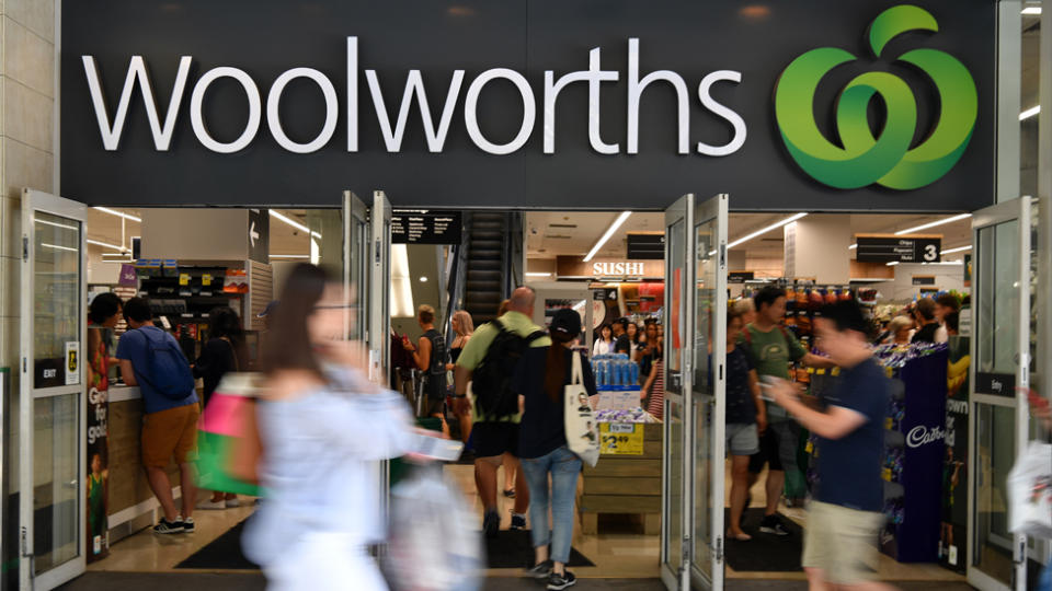 Pictured are shoppers outside a Woolworths supermarket. 