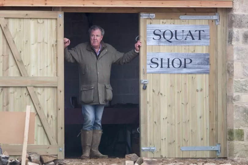 Jeremy Clarkson stands in the entrance of his Diddly Squat farm shop