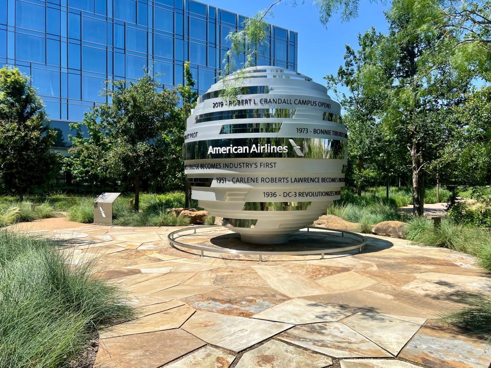 The "Globe of Firsts" sitting in the courtyard surrounded by trees with the hotel in the background.