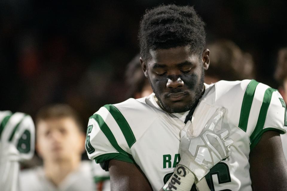 Northern Highlands hosts Ramapo in the North 1, Group 4 football title game in Allendale on Friday, Nov. 26, 2021. R #26 JJ Jenkins holds his hand to his heart during a moment of silence for the late coach Drew Gibbs. This is the first game for Ramapo since the death of Coach Drew Gibbs.