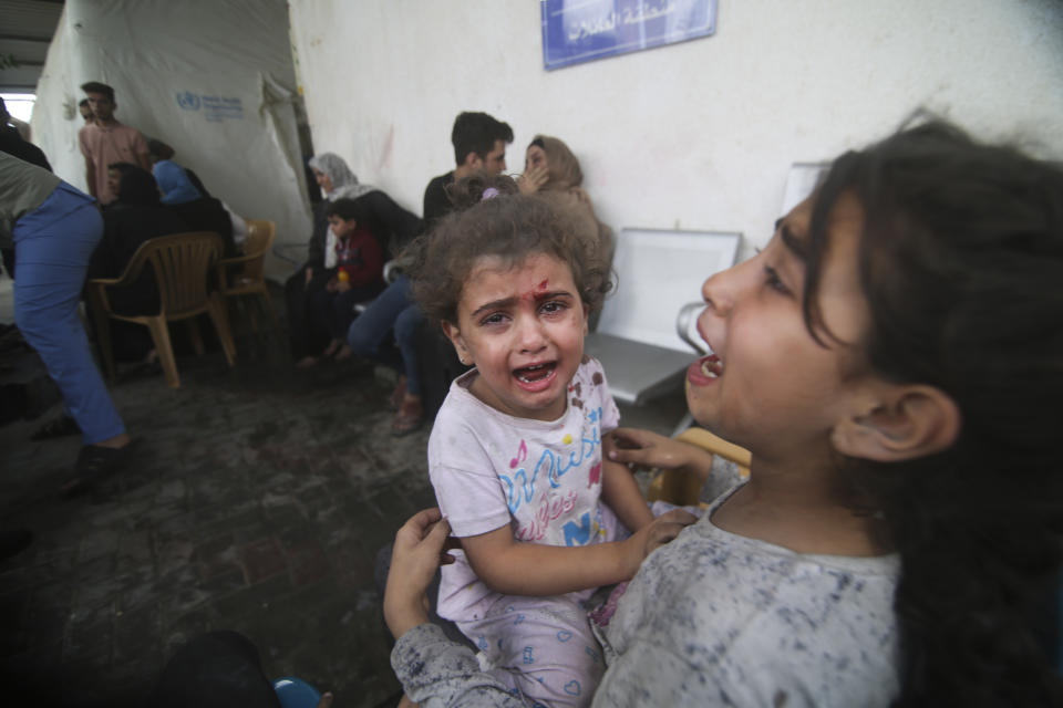 Palestinian children wounded in Israeli strikes cry outside a hospital in Rafah refugee camp, southern Gaza Strip, Thursday, Oct. 12, 2023. (AP Photo/Hatem Ali)