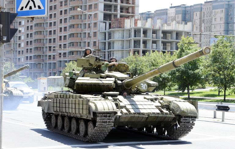 Pro-Russian militants drive a tank in the eastern Ukrainian city of Donetsk, on July 21, 2014