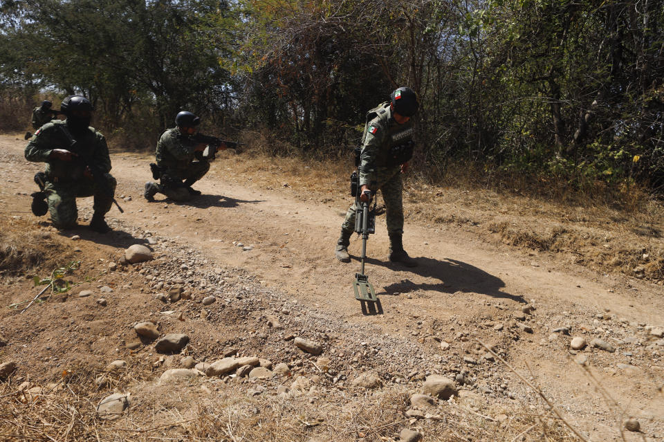 FILE - Mexican Army soldiers demonstrate a search for anti-personnel mines during a media presentation near Naranjo de Chila, in the municipality of Aguililla, Michoacan state, Mexico, Feb. 18, 2022. Authorities say that a coordinated series of roadway bomb blasts on July 11, 2023 in Tlajomulco, Jalisco state killed four police officers and two civilians, as well as wounded 14 others. (AP Photo/Armando Solis, File)