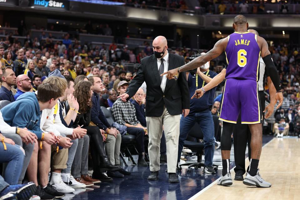 LeBron James #6 of the Los Angeles Lakers points out fans that he had a disturbance with to security during the game against the Indiana Pacers