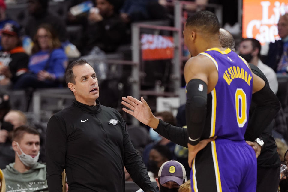 Los Angeles Lakers head coach Frank Vogel talks with guard Russell Westbrook (0) during the first half of an NBA basketball game against the Detroit Pistons, Sunday, Nov. 21, 2021, in Detroit. (AP Photo/Carlos Osorio)