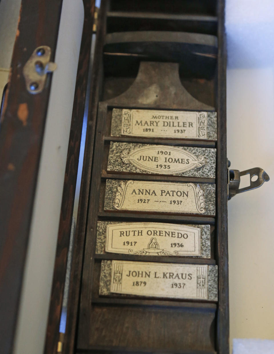 This Oct. 29, 2013, photo taken in Evanston, Ill., shows a traveling salesman's kit of headstone designs, at the Charles Deering McCormick Library of Special Collections. The kit is one of many artifacts from the “Death Collection” - an archive of death-related oddities once owned by horror novelist and screenwriter Michael McEachern McDowell that have been purchased by Northwestern University. (AP Photo/M. Spencer Green)