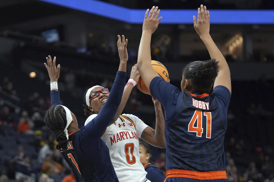 Maryland guard Shyanne Sellers (0) looks to shoot as Illinois guard Genesis Bryant (1) and center Camille Hobby (41) defend during the second half of an NCAA college basketball game at the Big Ten women's tournament Thursday, March 7, 2024, in Minneapolis. (AP Photo/Abbie Parr)