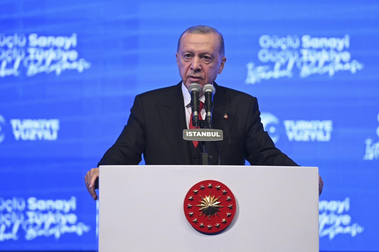 President Recep Tayyip Erdogan at the microphone.