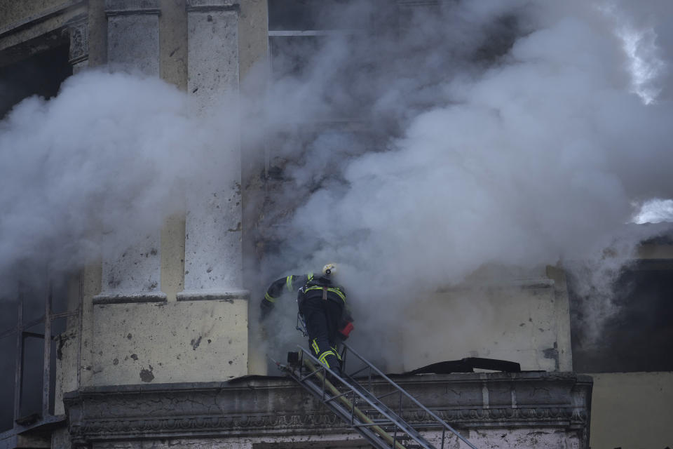A firefighter enters a building at the site after a Russian attack in Kyiv, Ukraine, Thursday, March 21, 2024. Around 30 cruise and ballistic missiles were shot down over Kyiv on Thursday morning, said Serhii Popko, the head of Kyiv City Administration. The missiles were entering Kyiv simultaneously from various directions in a first missile attack on the capital in 44 days. (AP Photo/Vadim Ghirda)