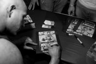 Nick Scott signs autographs at The Texas Shredder in Austin. (Photo by Lauren Fleishman for TIME) <br> <br> <a href="http://lightbox.time.com/2012/10/15/wheelchair-bodybuilders/#1" rel="nofollow noopener" target="_blank" data-ylk="slk:Click here to see the full collection and story at TIME.com;elm:context_link;itc:0;sec:content-canvas" class="link ">Click here to see the full collection and story at TIME.com</a>