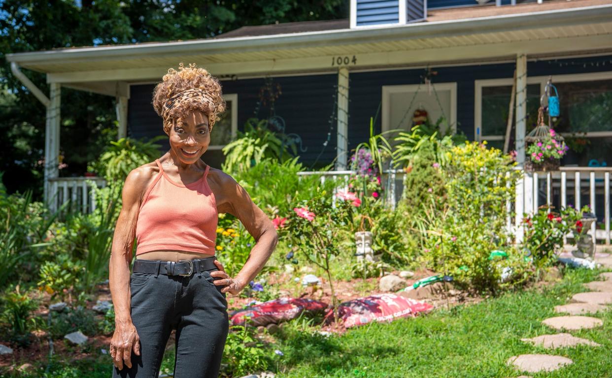 Birdena Oakley-Carlisle poses outside her home on RCA Park Drive on Wednesday, Aug. 16, 2023. The home was built for her as part of the Autumnview land trust neighborhood in the '90s.