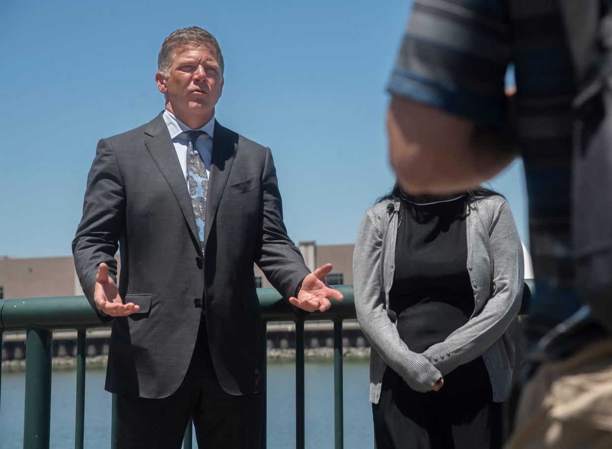 Attorney Dan Gilleon, with his client "Jane Doe No. 2," speaks at a news conference in downtown Stockton about sexual assault claims made by three women are making against Stockton Police Sgt. Nicholas Bloed.