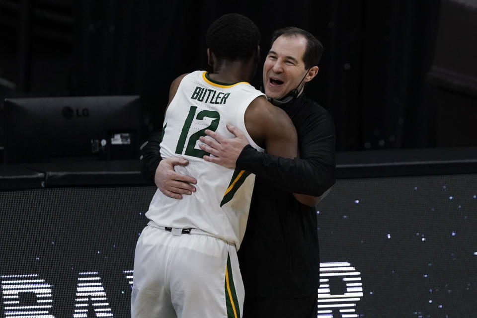 Baylor guard Jared Butler (12) gets a hug from head coach Scott Drew during the second half of a men's Final Four NCAA college basketball tournament semifinal game against Houston, Saturday, April 3, 2021, at Lucas Oil Stadium in Indianapolis. (AP Photo/Michael Conroy)