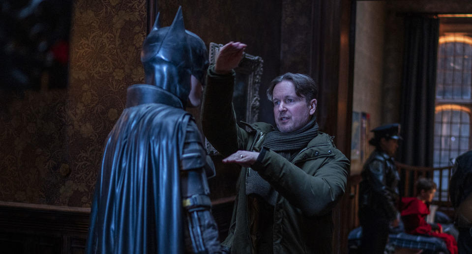 Robert Pattinson receives direction from Matt Reeves on the set of The Batman. (Warner Bros.)