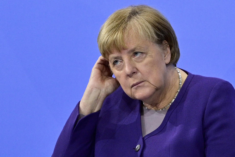 German Chancellor Angela Merkel attends a press conference following a meeting with the heads of government of Germany's federal states at the Chancellery in Berlin, Thursday, Dec. 2, 2021. Merkel said Thursday that people who aren't vaccinated will be excluded from nonessential stores, cultural and recreational venues, and parliament will consider a general vaccine mandate, as part of an effort to curb coronavirus infections that again topped 70,000 newly confirmed cases in a 24-hour period. (John Macdougall/Pool Photo via AP)