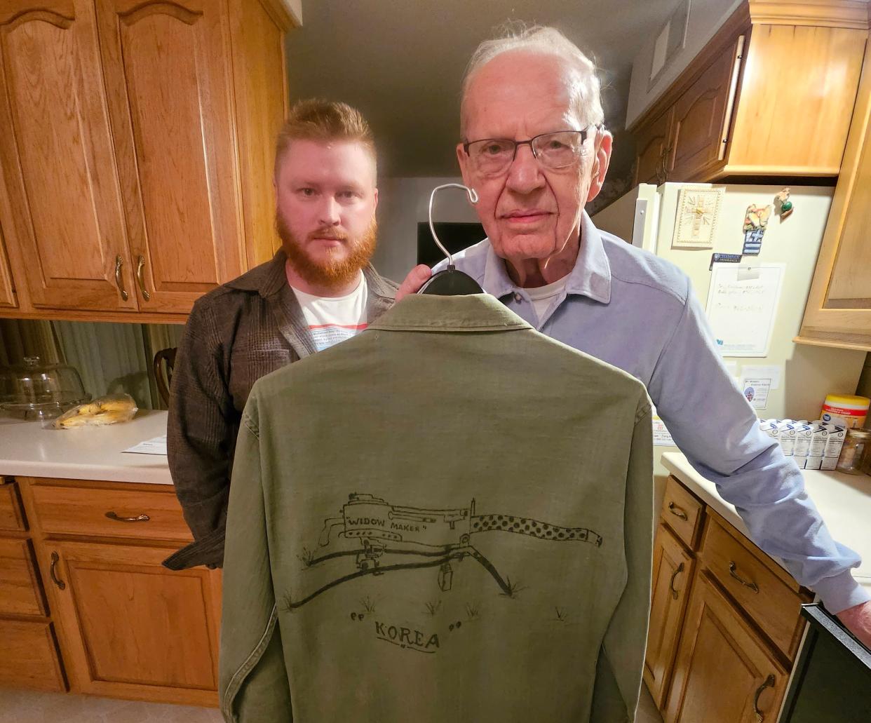 Ryan Walkowski, who is writing a book relating the stories of Korean War veterans, poses with Bert Ruechel of Wausau, who was a Marine machine gunner during the war.