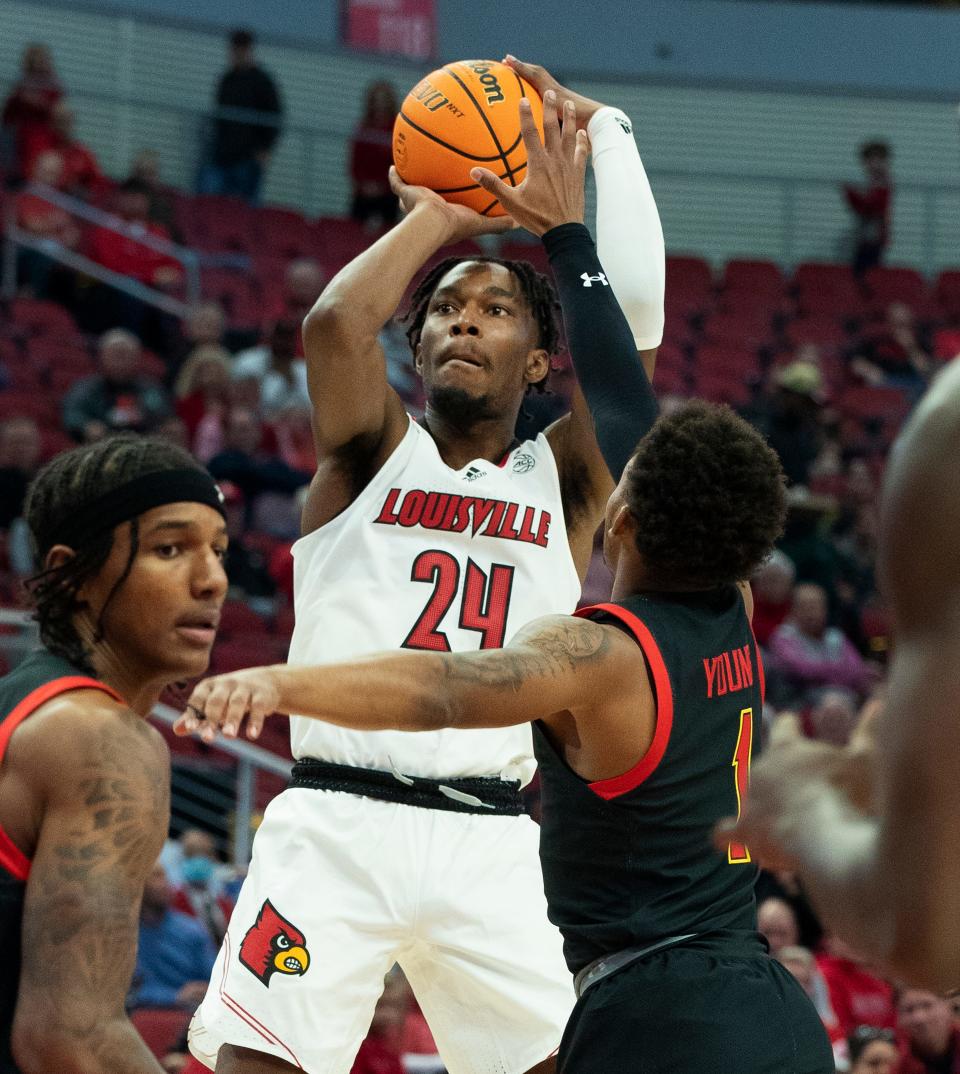 U of Lâ€™s Jae'Lyn Withers (24) shoots against a Maryland defender during their game at the Yum Center in Louisville, Ky. on Nov. 29, 2022.  