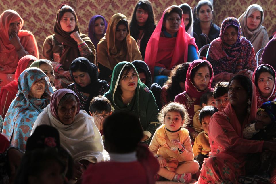 People attend a mass on Christmas day at Fatima Church in Islamabad