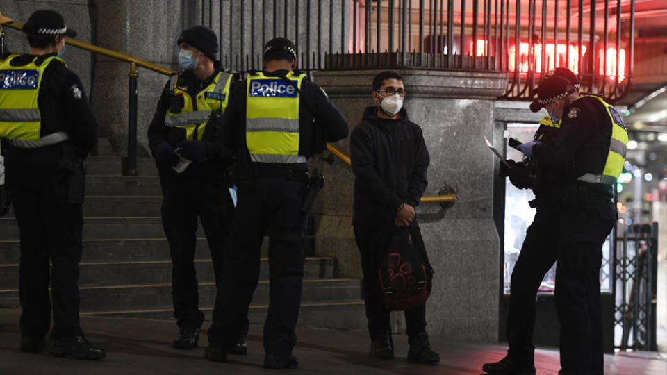 Melbourne Police check permits in front of Flinders Street Station.