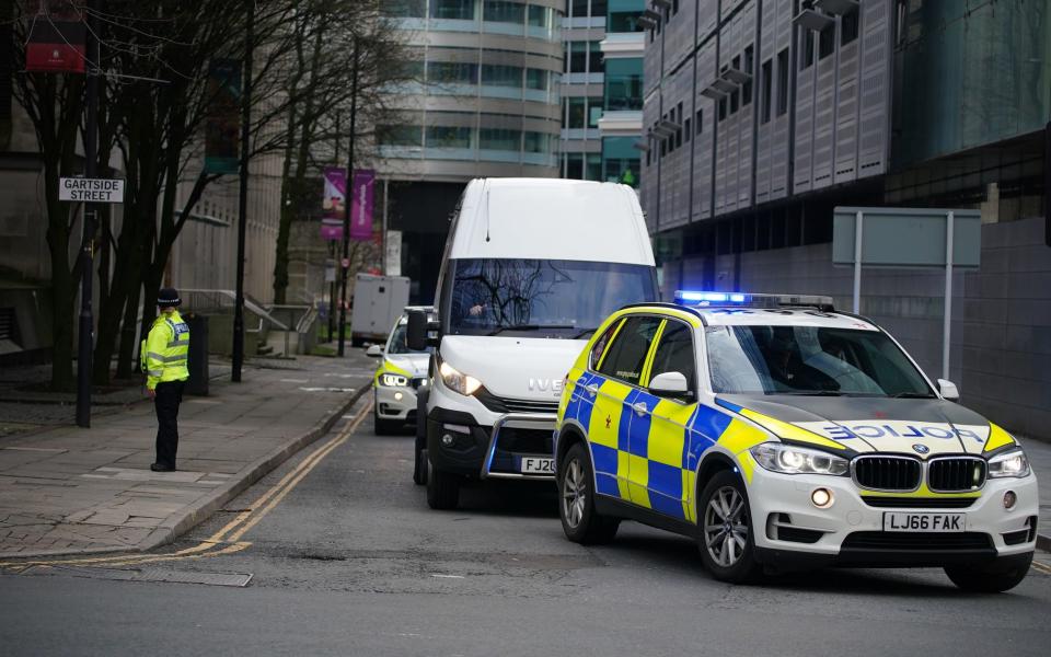 A van believed to be carrying Thomas Cashman is driven away from Manchester Crown Court under police escort - PA