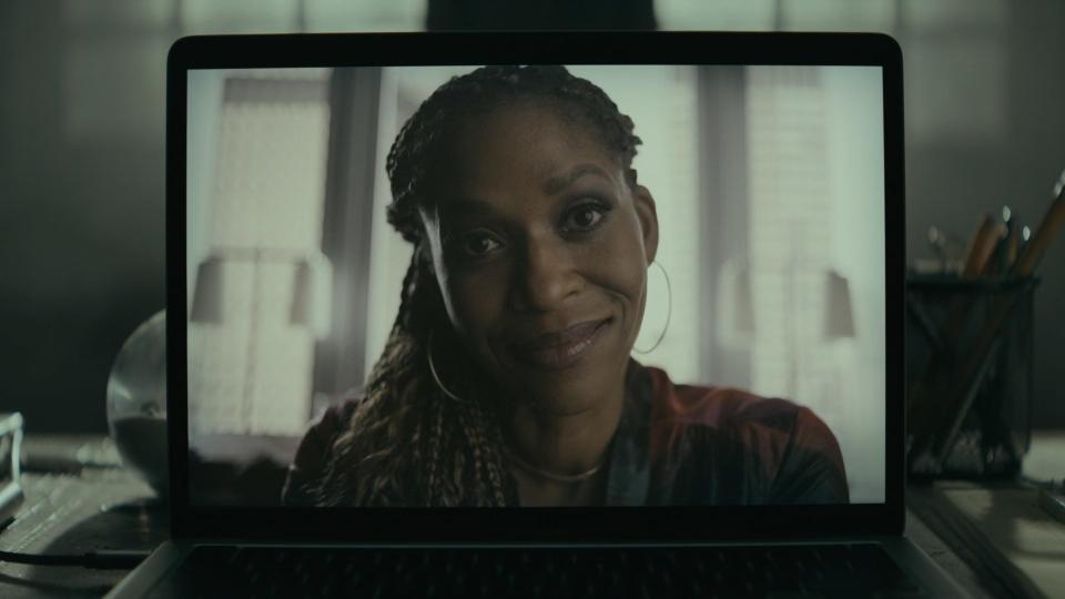 Merrin Dungey's face appears on the screen of a laptop in a video call