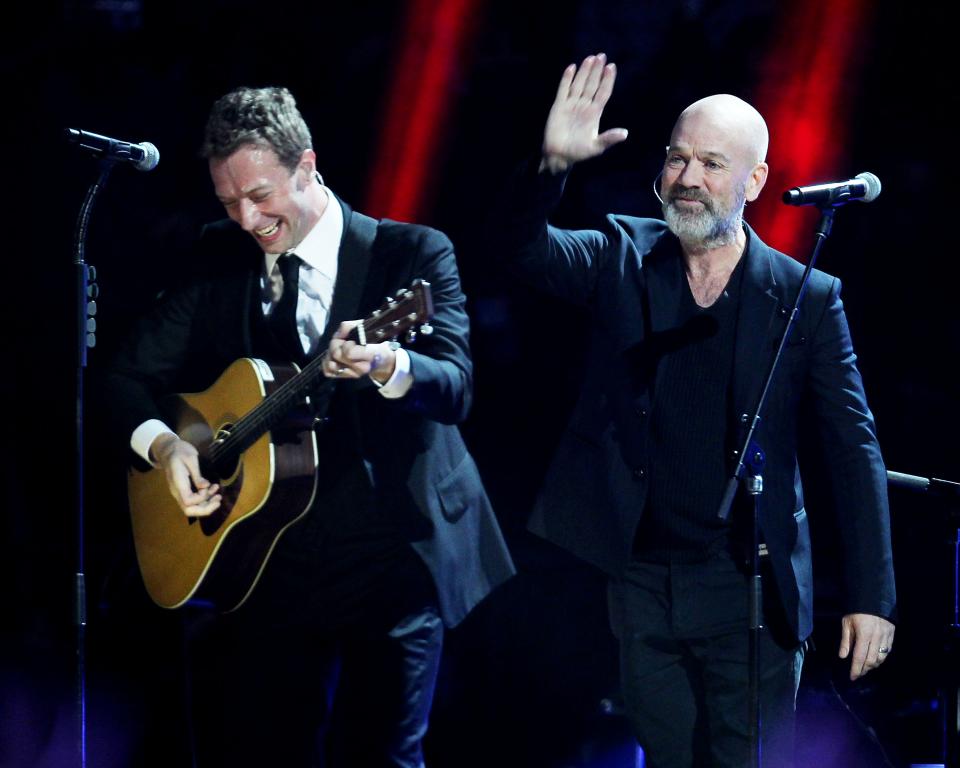 This image released by Starpix shows Chris Martin, left, and Michael Stipe at the 12-12-12 The Concert for Sandy Relief at Madison Square Garden in New York on Wednesday, Dec. 12, 2012. Proceeds from the show will be distributed through the Robin Hood Foundation. (AP Photo/Starpix, Dave Allocca)