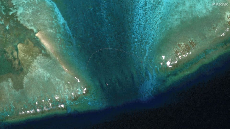 A satellite view of the a floating barrier at the entrance to Scarborough Shoal on February 22, 2024. The Philippines accused China's coast guard of setting up the barrier at the mouth of the disputed fishing ground. - Maxar Technologies