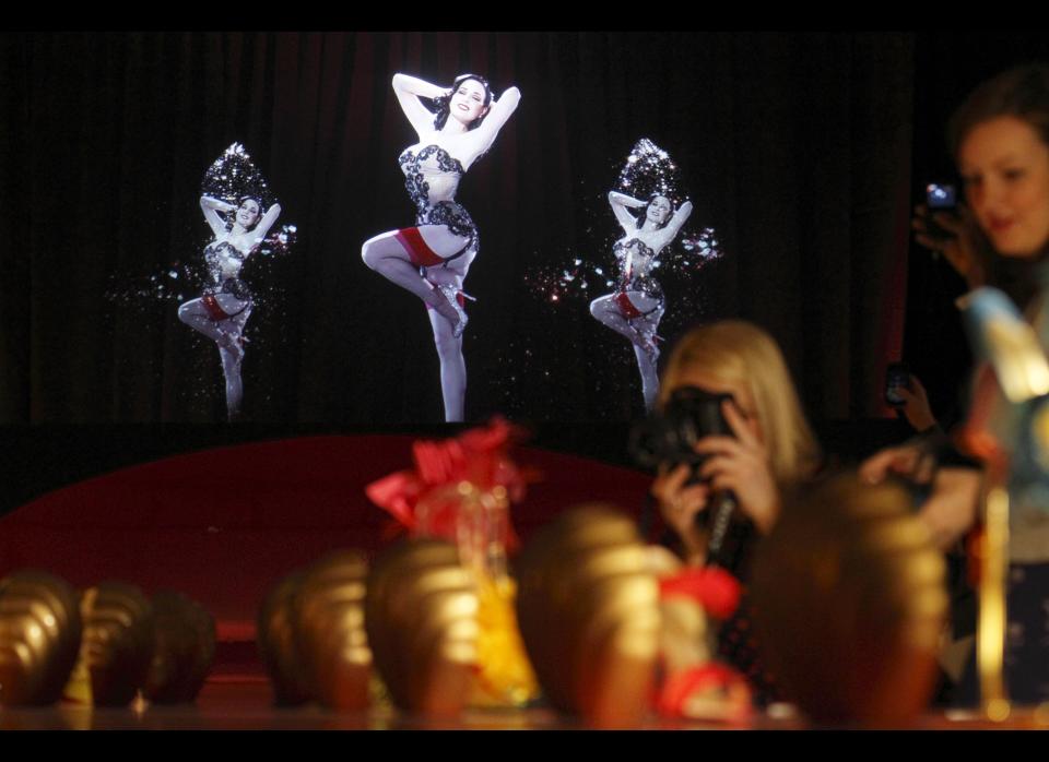 A picture shows a 3D hologram of a burlesque dancer at a preview of an exhibition by French shoe designer Christian Louboutin showcasing 20 years of the famous red-soled shoes at the Design Museum in London on April 30, 2012.   