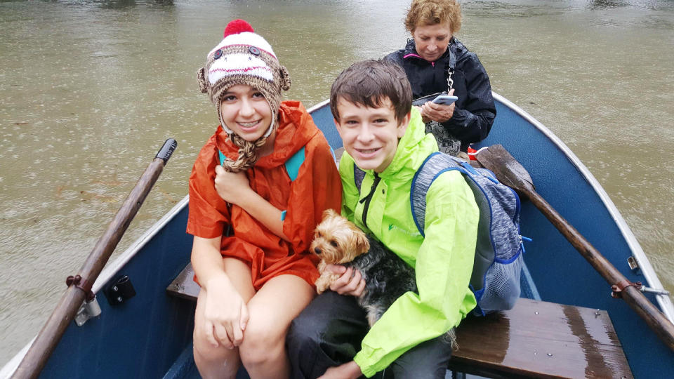 Bobbie, Gracie and Nolen Shumaker boated to safety Monday with their dog Coco in tow. (Photo: David Lohr/HuffPost)