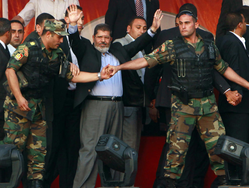 Egypt’s Islamist President-elect Mohammed Morsi waves to supporters while surrounded by presidential guards in Cairo’s Tahrir Square in June 2012. (Photo: Amr Abdallah Dalsh/Reuters)