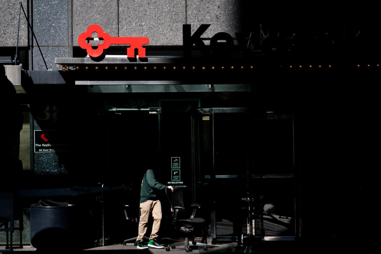 Movers help tenants leave the Key Bank building on Tuesday in Downtown. Several tenants expressed concern with how the building was being managed and have decided to move to a new location.