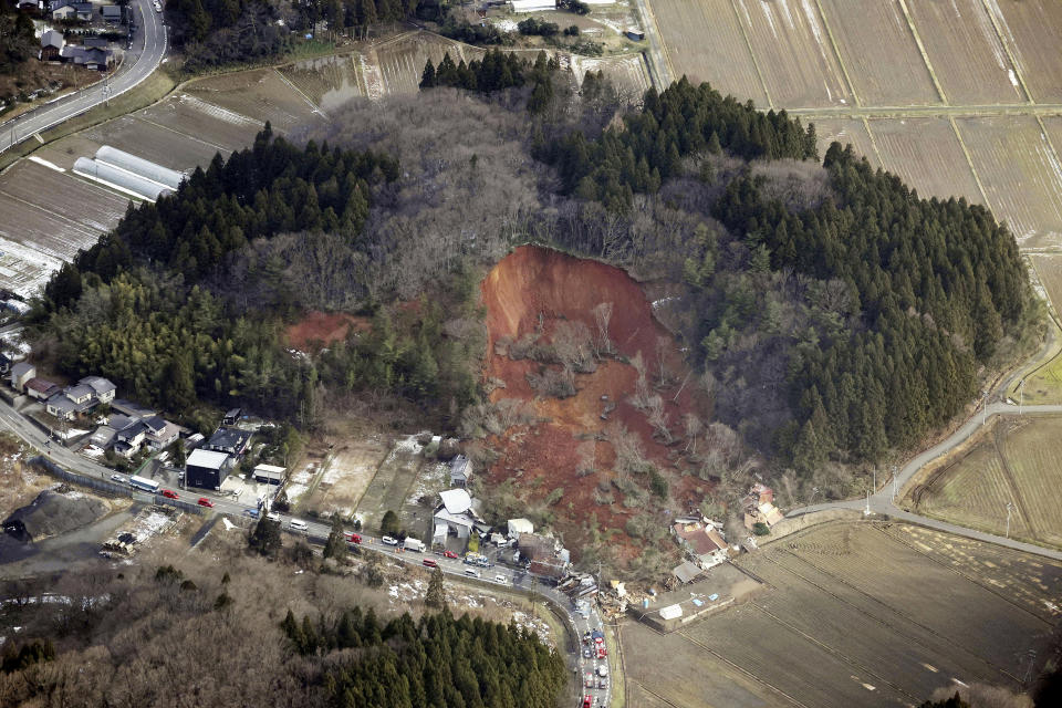 This aerial photo shows a landslide in Tsuruoka, Yamagata prefecture, north of Tokyo Saturday, Dec. 31, 2022. A landslide swallowed about a dozen homes in northern Japan Saturday. (Kyodo News via AP)