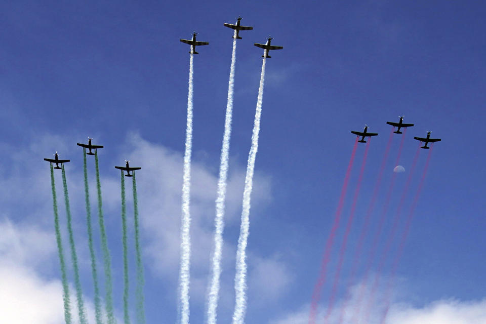 Mexican Air Force planes release smoke in the colors of the Mexican flag over the Independence Day military parade in the Zocalo, in Mexico City, Friday, Sept. 16, 2022. (AP Photo/Marco Ugarte)