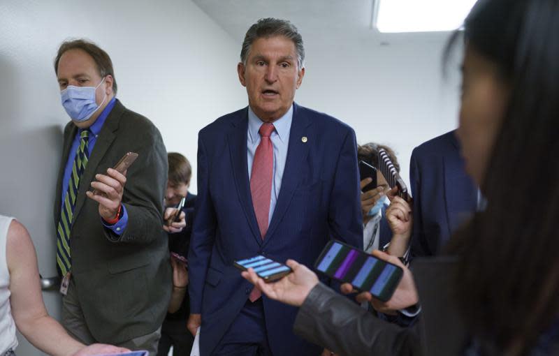 Sen. Joe Manchin, D-W.Va., is surrounded by reporters as senators rush to the chamber for votes ahead of the approaching Memorial Day recess, at the Capitol in Washington, Wednesday, May 26, 2021. (AP Photo/J. Scott Applewhite)