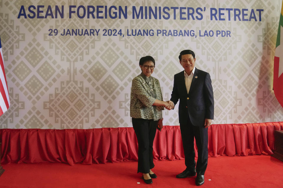 Indonesian Foreign Minister Retno Marsudi, left, shakes hands with Laos' Foreign Minister Saleumxay Kommasith during the Association of Southeast Asian Nations (ASEAN) Foreign Ministers retreat meeting in Luang Prabang, Laos,Monday, Jan. 29, 2024. (AP Photo/Sakchai Lalit)